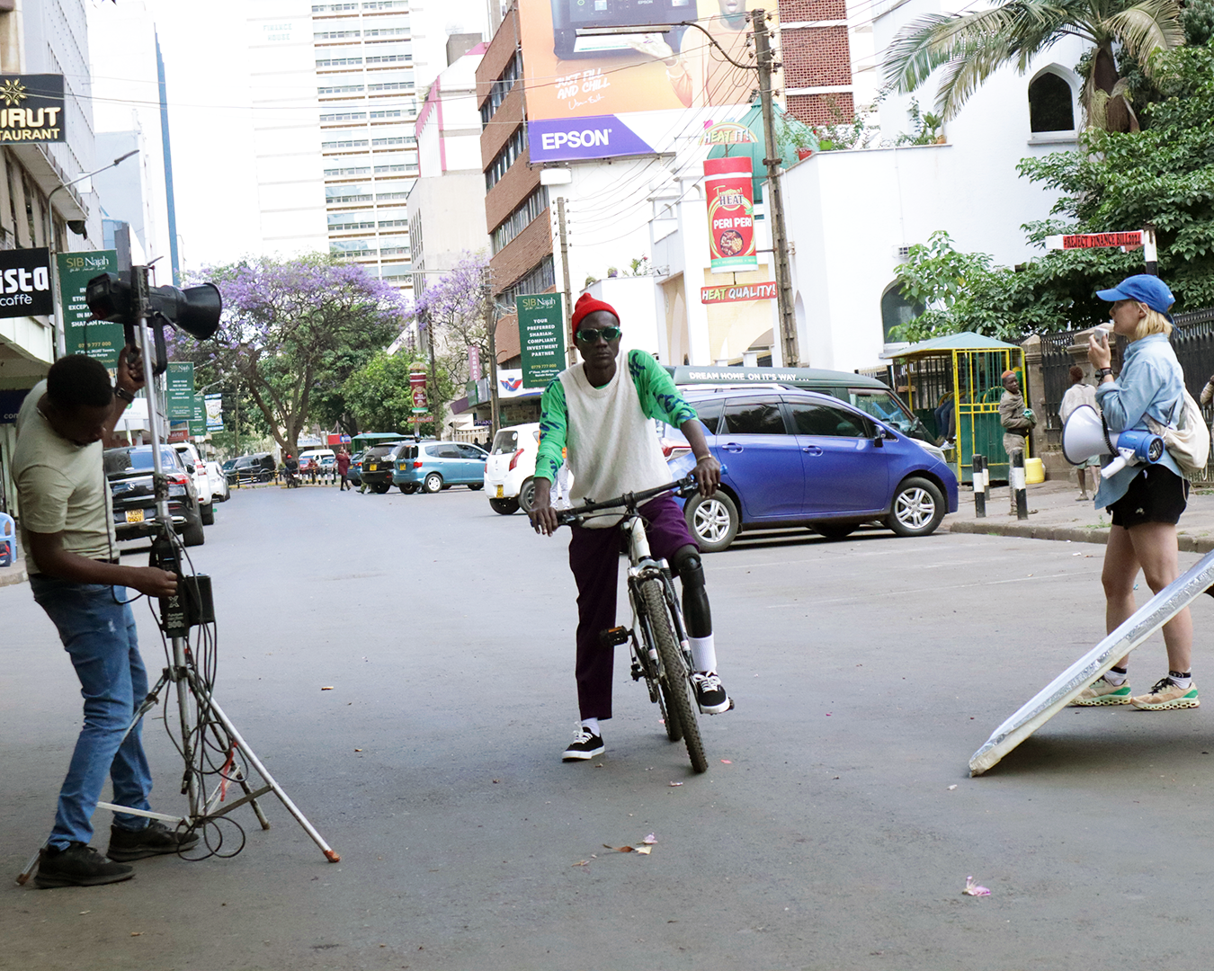 Tabu Ley Mungu Econi, an amputee from Uganda, riding his bike with his prosthetic leg.